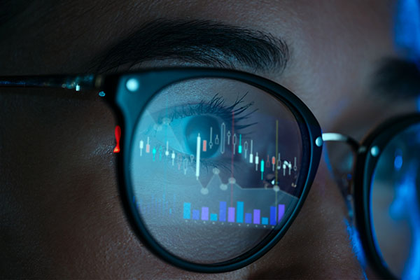 Reflection of technical analysis in someone's glasses