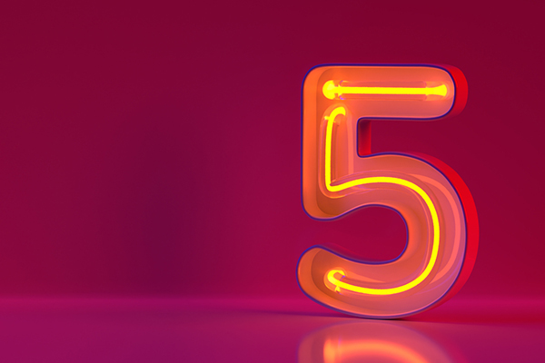 Glowing yellow neon number five on purple background