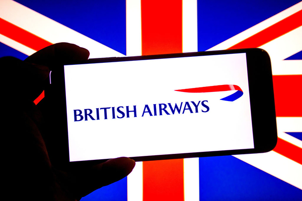 A British Airways logo on a smartphone with a flag of UK in the background, Getty