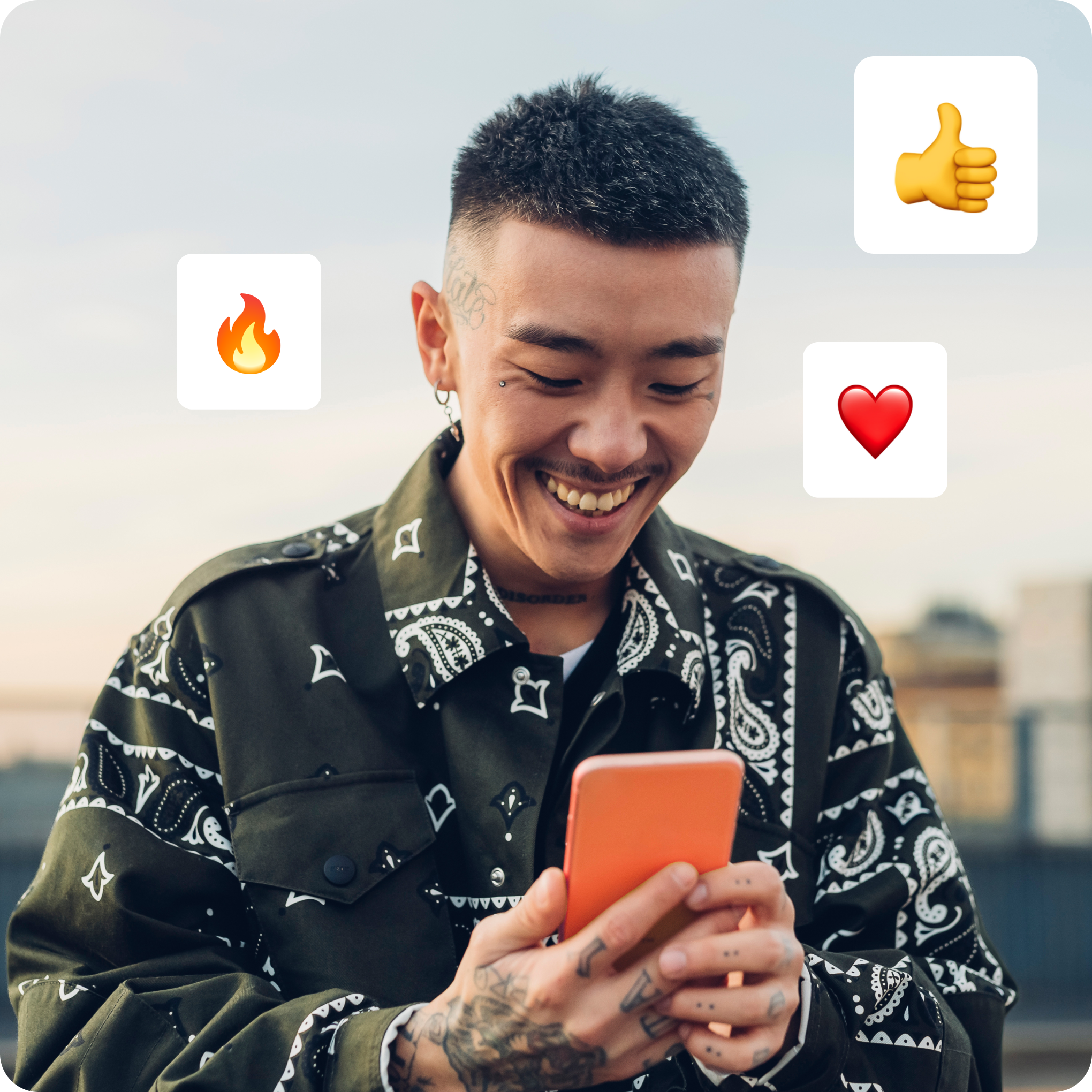 man smiling at phone with reaction emojis