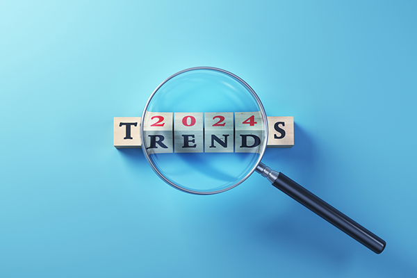 'Trends' written on wooden blocks standing selected with magnifying glass on blue background