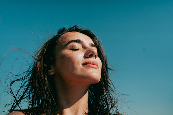 Woman with face turned up to the sun