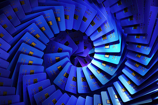 Blue coloured credit cards organized into swirl pattern, Getty