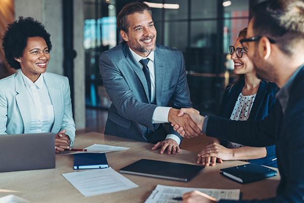 Two people in a meeting room shaking hands