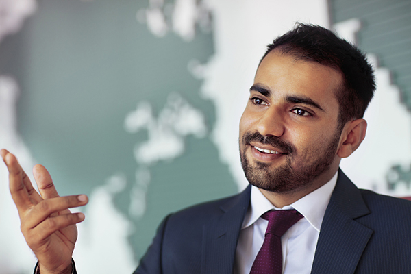 Investor talking in room with map on wall 