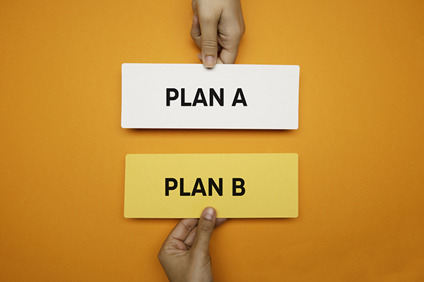 Plan A and Plan B signs against orange background