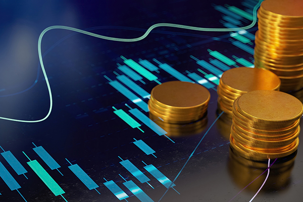 Gold coins against stock market graph