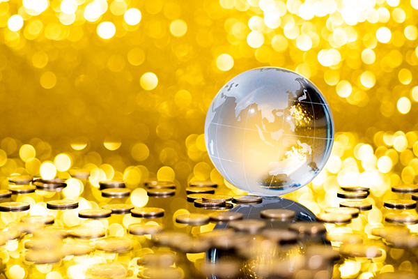 Transparent globe on golden coin pile