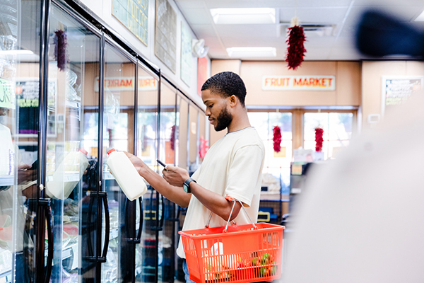 A man in a supermarket with a shopping basket