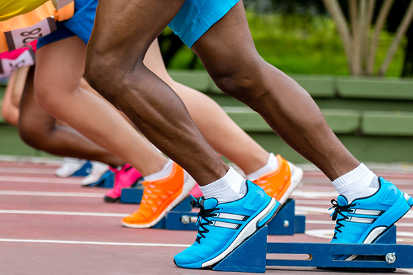 Group of athletes at the track ready to run