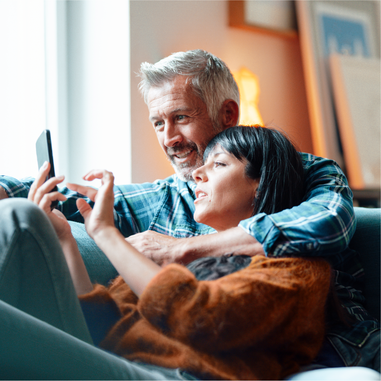 Couple looking at tax savings on mobile device