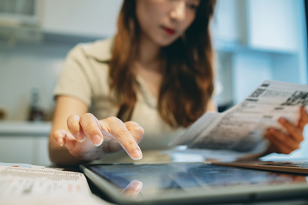Woman looking at energy bills, Getty