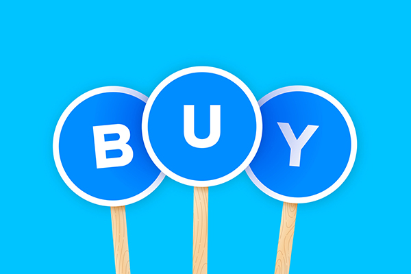 Signs spelling 'buy' being held up, Getty