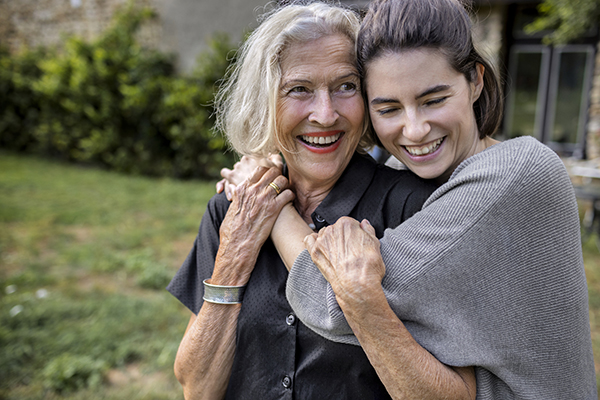 Mother hugging daughter, Getty