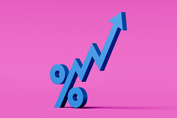 Percentage symbol with up arrow on pink background, Getty