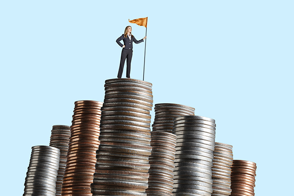Woman standing on coin stacks with a flag