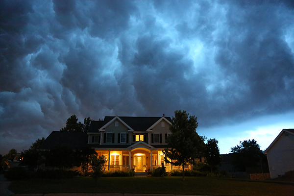 A house with a bad thunderstorm overhead