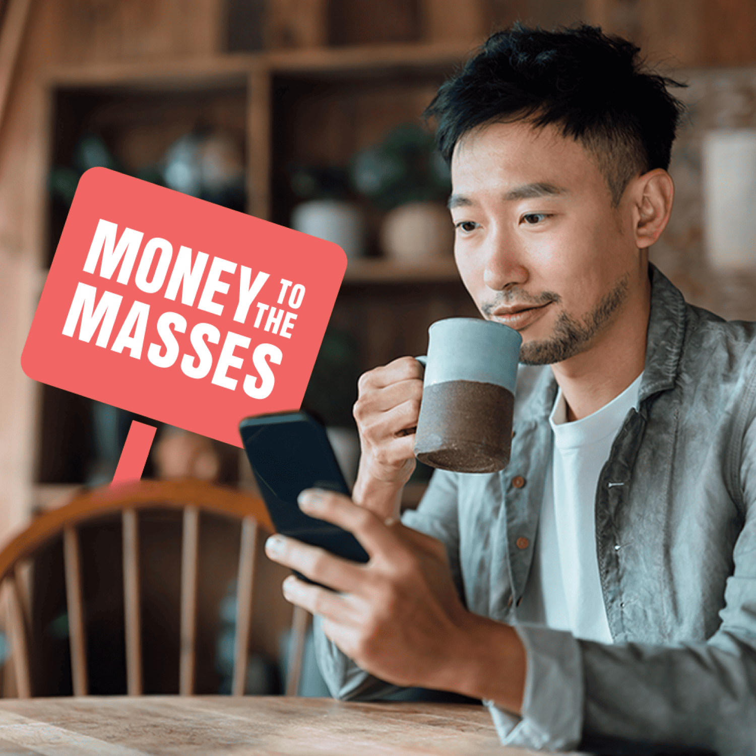 A hero image of man looking at mobile with mug. The image also contains the money to the masses logo.