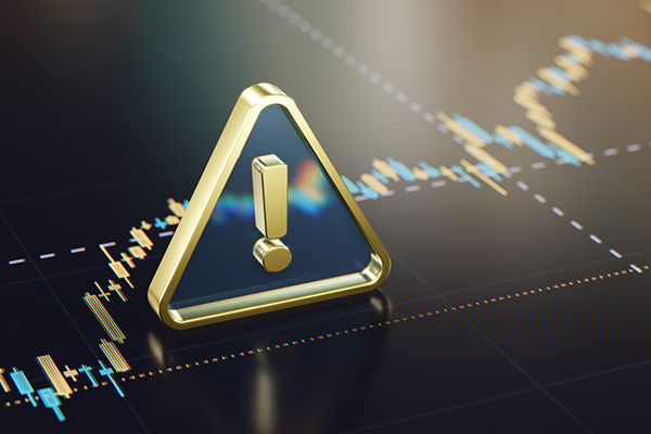 Financial market warning symbol on trading chart
