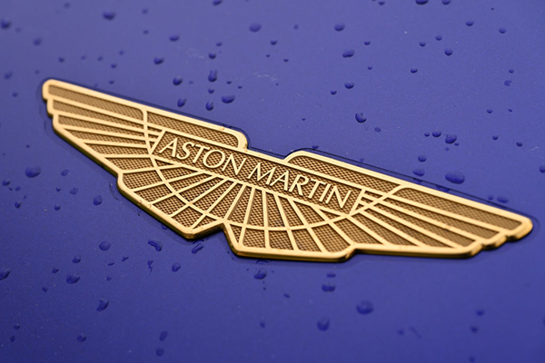 Aston Martin logo on a purple car, Getty