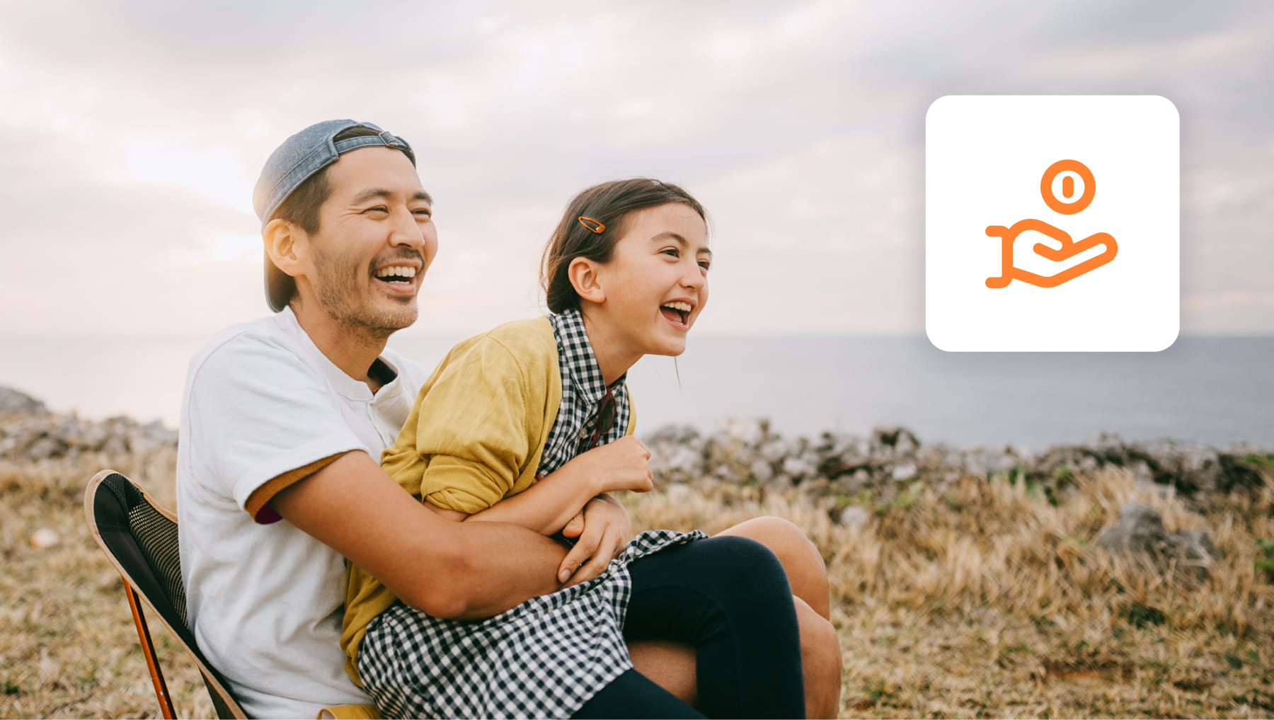 man and daughter laughing playing on coast 
