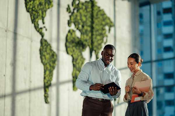 Two investors in front of world map
