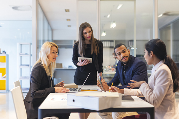Four people in an office having a meeting