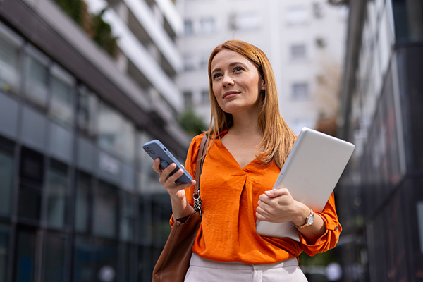 Woman thinking about an investment and looking at her phone