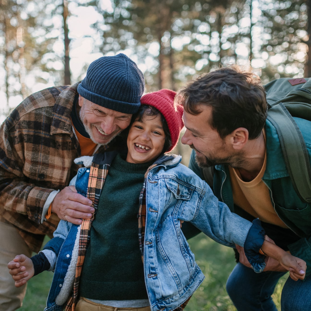 Image of three generations hiking outdoors in the woods