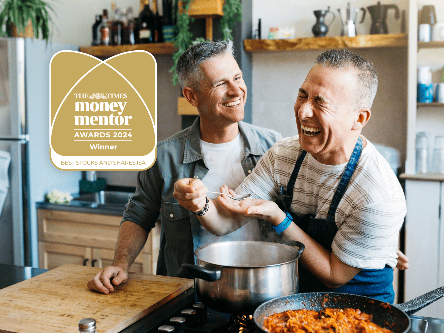 two men cooking dinner in kitchen whilst laughing money mentor award
