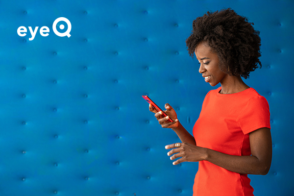 eyeQ Woman looking at tech stocks on her smartphone