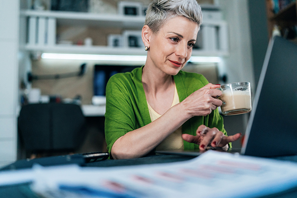 A woman sitting with a coffee and her various pensions