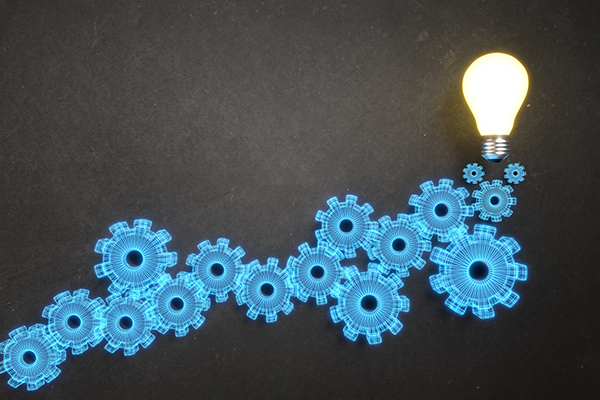 Blue cogs with an 'ideas' light bulb at the top