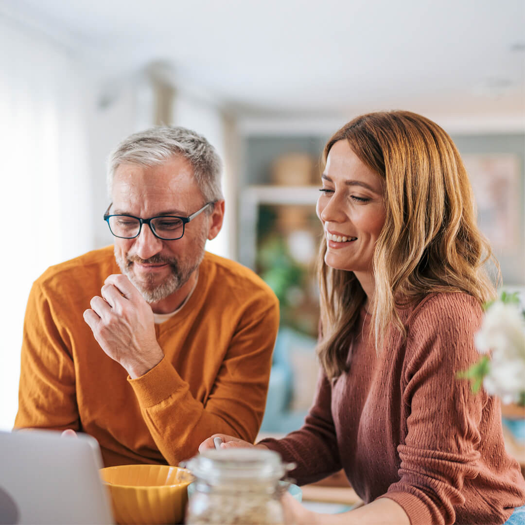 Couple viewing savings on laptop