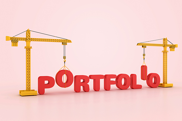 A crane lifting the words 'portfolio' up