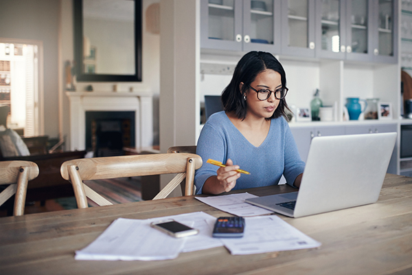 Woman thinking about about consolidation at the kitchen table