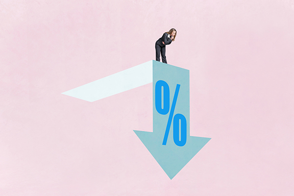 A woman looks down at falling interest rates