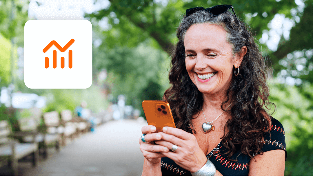 An image of a lady looking at investment trends on her mobile