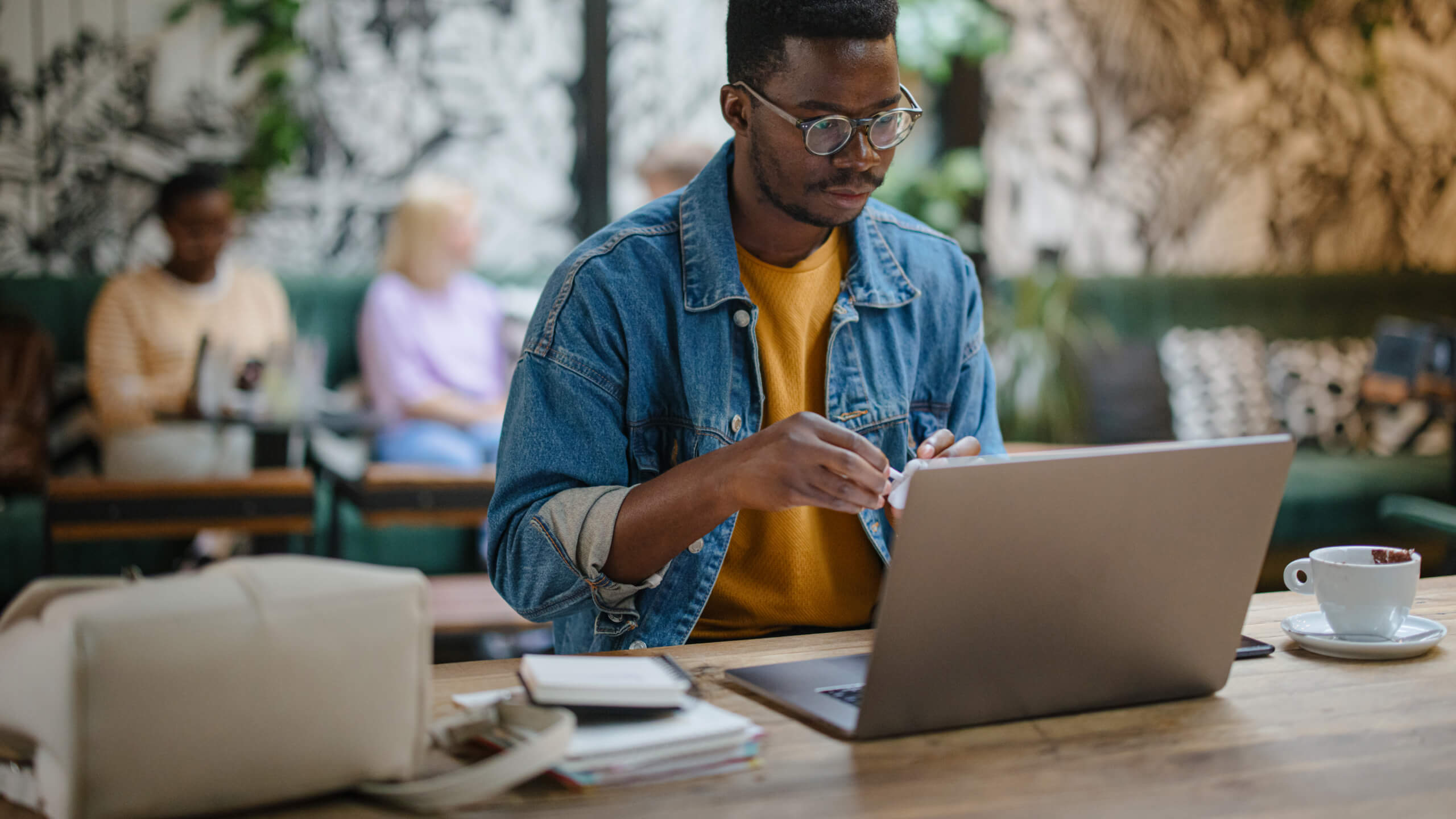 Man in cafe looking at laptop