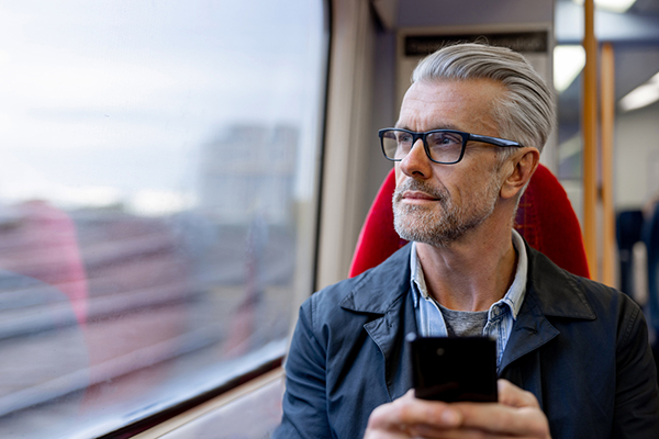 A man researching the state pension age on a train