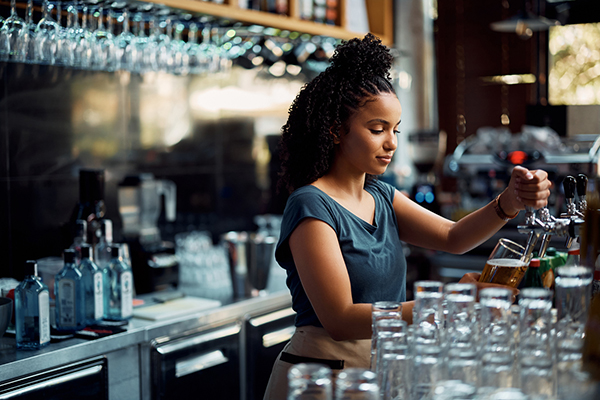 Woman pulling a pint in the pub