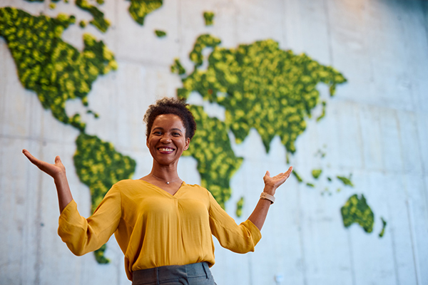 Female investor in front of a global map
