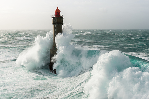 Lighthouse with huge waves, Getty