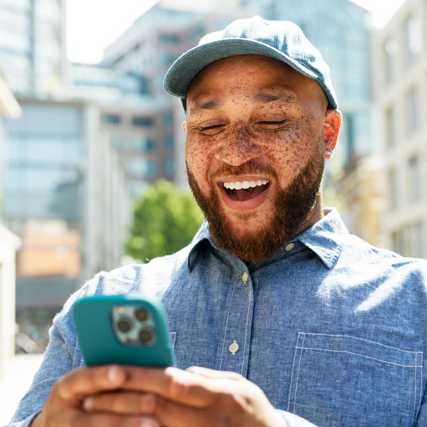 man in cap outdoors city excited