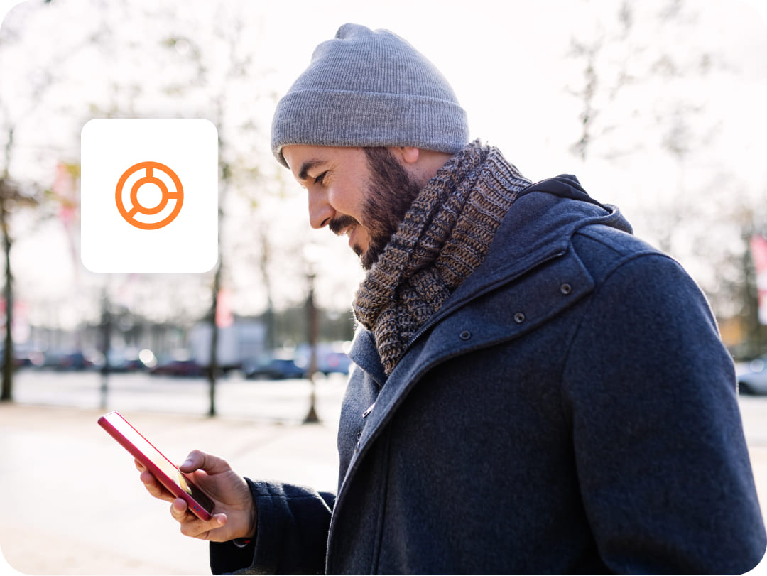 man outdoors winter cold with mobile icon chart