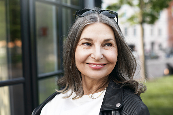 Newly retired woman wearing leather jacket and sunglasses