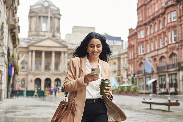 Woman looking at her mobile in the street
