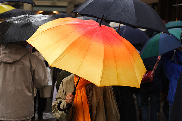 Bright yellow umbrella in the gloom