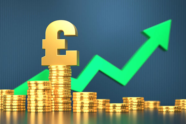 Pound symbol on coins and green growth arrow