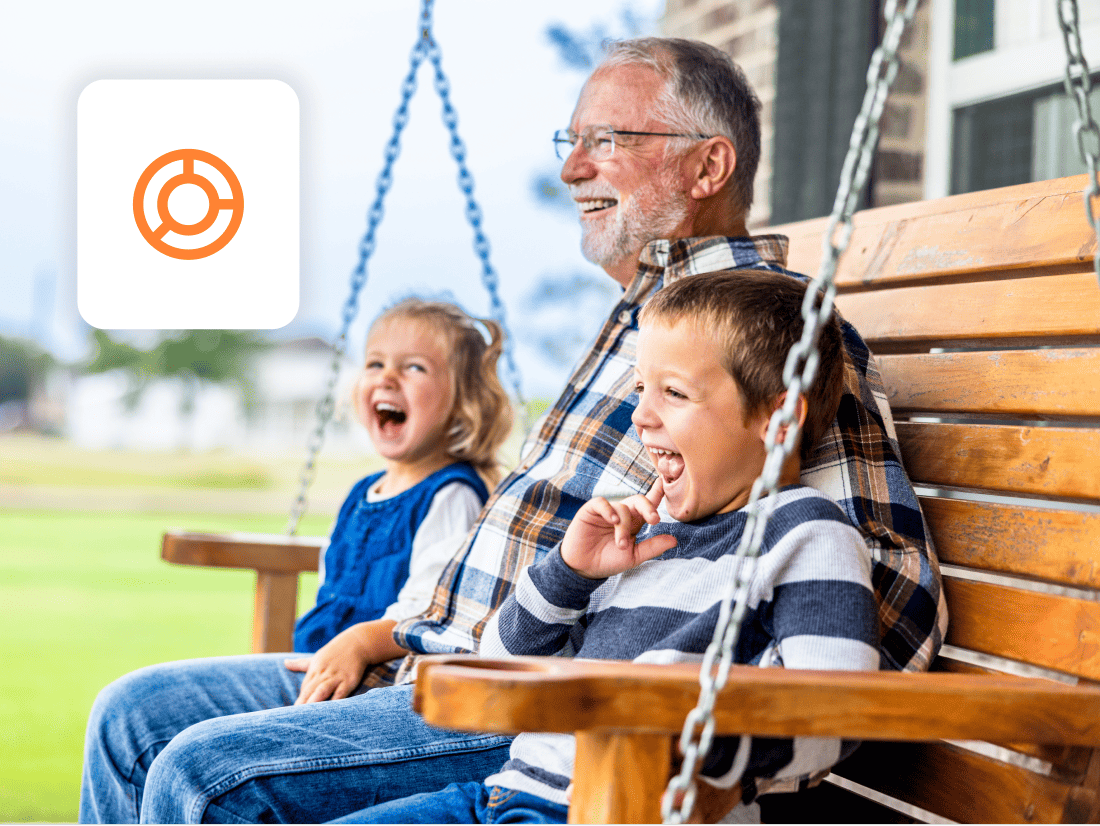 man-outdoors-on-bench-with-grandchildren